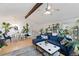 Open-concept living and dining space filled with plants, vaulted ceiling and ample light at 12466 E Amherst Cir, Aurora, CO 80014