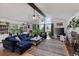 Bright, open-concept living room featuring a vaulted ceiling, wood floors, and a brick fireplace at 12466 E Amherst Cir, Aurora, CO 80014