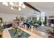Open-concept living room features a vaulted ceiling, wood floors, and a dining area at 12466 E Amherst Cir, Aurora, CO 80014