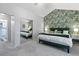 Bright main bedroom featuring patterned wallpaper, mirrored closet doors, and plush carpeting at 12466 E Amherst Cir, Aurora, CO 80014