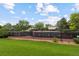 Exterior view of a community tennis court surrounded by green space and trees at 12466 E Amherst Cir, Aurora, CO 80014