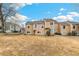 Townhouse backyard featuring a nice lawn space and exterior of a tan two story home at 13040 W 63Rd Pl # A, Arvada, CO 80004
