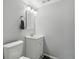 Clean, well-maintained bathroom with a toilet, vanity, sink, and standard overhead lighting at 13040 W 63Rd Pl # A, Arvada, CO 80004