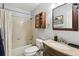 Standard bathroom design featuring a tub and shower combo, vanity, and wooden medicine cabinet at 13040 W 63Rd Pl # A, Arvada, CO 80004