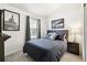 Cozy bedroom featuring a comfortable bed, accent wall, and framed artwork at 13040 W 63Rd Pl # A, Arvada, CO 80004