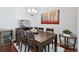 Dining room with large wooden table, chandelier, and an adjacent beverage cooler at 13040 W 63Rd Pl # A, Arvada, CO 80004