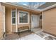 Inviting front entrance with white door, bay window and bench, perfect for a cozy and charming welcome at 13040 W 63Rd Pl # A, Arvada, CO 80004