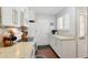 Compact and efficient kitchen features white cabinetry, laminate countertops and essential appliances at 13040 W 63Rd Pl # A, Arvada, CO 80004
