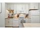 Efficient kitchen features white appliances, bright cabinets, and laminate countertops at 13040 W 63Rd Pl # A, Arvada, CO 80004