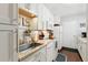 Bright kitchen features white appliances, bright cabinets, and laminate countertops at 13040 W 63Rd Pl # A, Arvada, CO 80004