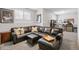 Spacious living room with a large couch, neutral walls, and media center at 13040 W 63Rd Pl # A, Arvada, CO 80004