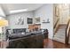 Spacious living room with vaulted ceilings, brick fireplace and hardwood floors at 13040 W 63Rd Pl # A, Arvada, CO 80004