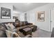 Spacious living room with a large couch, neutral walls, and media center at 13040 W 63Rd Pl # A, Arvada, CO 80004