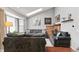 Bright living room with vaulted ceilings, skylights, and a cozy brick fireplace at 13040 W 63Rd Pl # A, Arvada, CO 80004