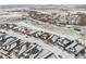 Aerial view of a neighborhood with snow-covered rooftops, showcasing the community layout and surrounding landscape at 6592 Club Villa Rd, Parker, CO 80134