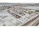 Aerial view of a snow-covered housing development, showcasing the layout and surrounding landscape at 6592 Club Villa Rd, Parker, CO 80134