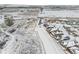 Scenic aerial view of residential area covered in snow, highlighting neighborhood layout and nearby open space at 6592 Club Villa Rd, Parker, CO 80134