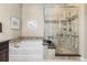 Luxurious bathroom with soaking tub and separate tiled shower with glass door at 6592 Club Villa Rd, Parker, CO 80134