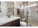 Clean bathroom featuring tile flooring, tile shower, and granite sink at 6592 Club Villa Rd, Parker, CO 80134