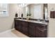 Elegant bathroom with double vanity, dark wood cabinetry, and a large mirror at 6592 Club Villa Rd, Parker, CO 80134