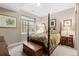 Charming bedroom with hardwood bed frame, complemented by decorative pillows and bedside tables at 6592 Club Villa Rd, Parker, CO 80134