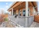 Inviting covered porch featuring neutral tones, decorative elements, and outdoor fireplace for cozy relaxation at 6592 Club Villa Rd, Parker, CO 80134