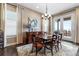 Elegant dining room with modern chandelier, complemented by a stylish buffet, perfect for hosting dinner parties at 6592 Club Villa Rd, Parker, CO 80134