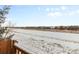 Scenic winter landscape view, showcasing a serene, snow-covered open space, as seen from the property at 6592 Club Villa Rd, Parker, CO 80134