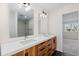 Bathroom featuring double vanity with wood drawers, black accents and modern shower at 2259 Kipling St, Lakewood, CO 80215
