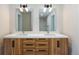 Modern bathroom with a double vanity and wood grain cabinets at 2259 Kipling St, Lakewood, CO 80215