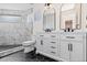 Bathroom featuring double vanity, shower, and black tile flooring at 2259 Kipling St, Lakewood, CO 80215