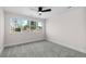 Bright bedroom features a ceiling fan, plush carpet and large window with natural light at 2259 Kipling St, Lakewood, CO 80215