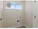 Unfinished laundry room ready for washer and dryer with a window at 2259 Kipling St, Lakewood, CO 80215