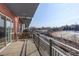 Spacious balcony overlooking a serene landscape with a river and train tracks at 1438 Little Raven St # 306, Denver, CO 80202