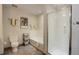 Bathroom including a shower with glass door, tub, toilet and coordinating artwork at 1438 Little Raven St # 306, Denver, CO 80202