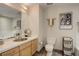 Bathroom featuring a vanity with stainless steel sink, toilet, and decorative artwork at 1438 Little Raven St # 306, Denver, CO 80202