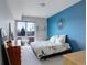 Bright bedroom featuring a balcony, carpet, and a vibrant blue accent wall at 1438 Little Raven St # 306, Denver, CO 80202