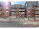 Modern brick building with multiple balconies and street access, enhanced by landscaping at 1438 Little Raven St # 306, Denver, CO 80202