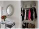 Entryway featuring glass table with flowers, decorative mirror and closet with organized storage at 1438 Little Raven St # 306, Denver, CO 80202