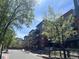 Apartment exterior featuring multiple balconies and fresh spring trees at 1438 Little Raven St # 306, Denver, CO 80202
