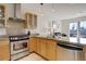 Well-equipped kitchen with stainless steel appliances, granite counters, and ample cabinet space at 1438 Little Raven St # 306, Denver, CO 80202