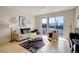 Bright living room featuring a cozy seating area and a sliding glass door to the balcony at 1438 Little Raven St # 306, Denver, CO 80202