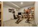 Finished basement recreation room with home gym equipment and ample shelving at 5401 Antler Run, Littleton, CO 80125