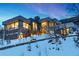 Modern home exterior with large windows and snowy landscaping at 5401 Antler Run, Littleton, CO 80125