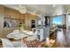 Modern kitchen with white table and chairs, and colorful rug at 5401 Antler Run, Littleton, CO 80125