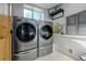 Convenient laundry room with washer, dryer, and storage at 5401 Antler Run, Littleton, CO 80125