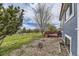 Expansive backyard with a well-maintained lawn, a charming white fence, and a wooden deck at 10987 Cannonade Dr, Parker, CO 80138