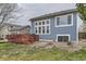 View of the home's back exterior, deck, and well-manicured lawn, perfect for outdoor gatherings at 10987 Cannonade Dr, Parker, CO 80138
