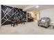Finished basement featuring a piano, geometrically painted wall, and comfortable seating at 10987 Cannonade Dr, Parker, CO 80138