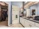 Blue bathroom featuring a walk-in closet, walk-in shower, vanity, and mirrors at 10987 Cannonade Dr, Parker, CO 80138